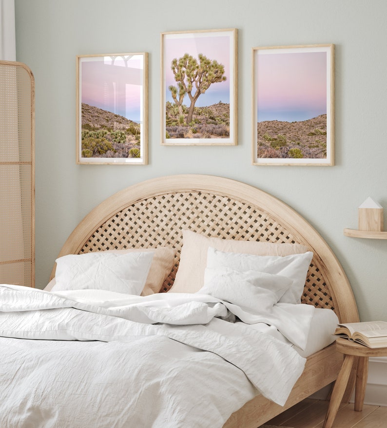A wall art set of 3 framed or unframed Joshua Tree National Park prints.  This desert wall art showcases a stunning Joshua Tree and the desert terrain and plants in a breathtaking Pink sunset filled with Pink and Purple hues. Modern gallery wall set
