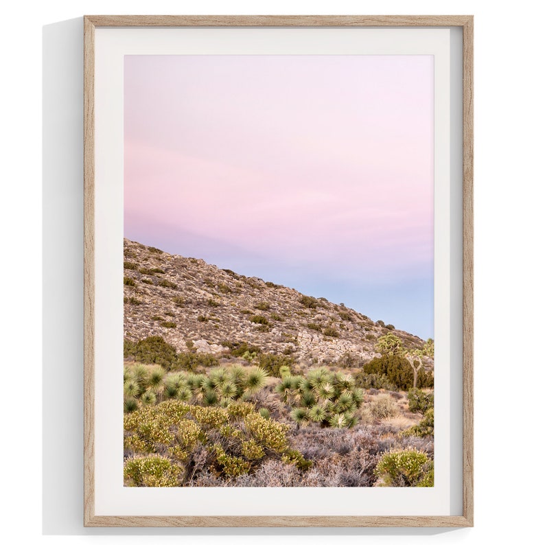 A wall art set of 3 framed or unframed Joshua Tree National Park prints.  This desert wall art showcases a stunning Joshua Tree and the desert terrain and plants in a breathtaking Pink sunset filled with Pink and Purple hues. Modern gallery wall set