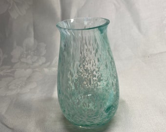 May include: A small, clear glass vase with a speckled, light green and white design.