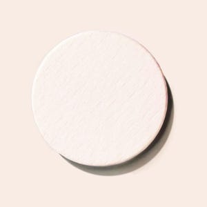 May include: A white round makeup sponge.