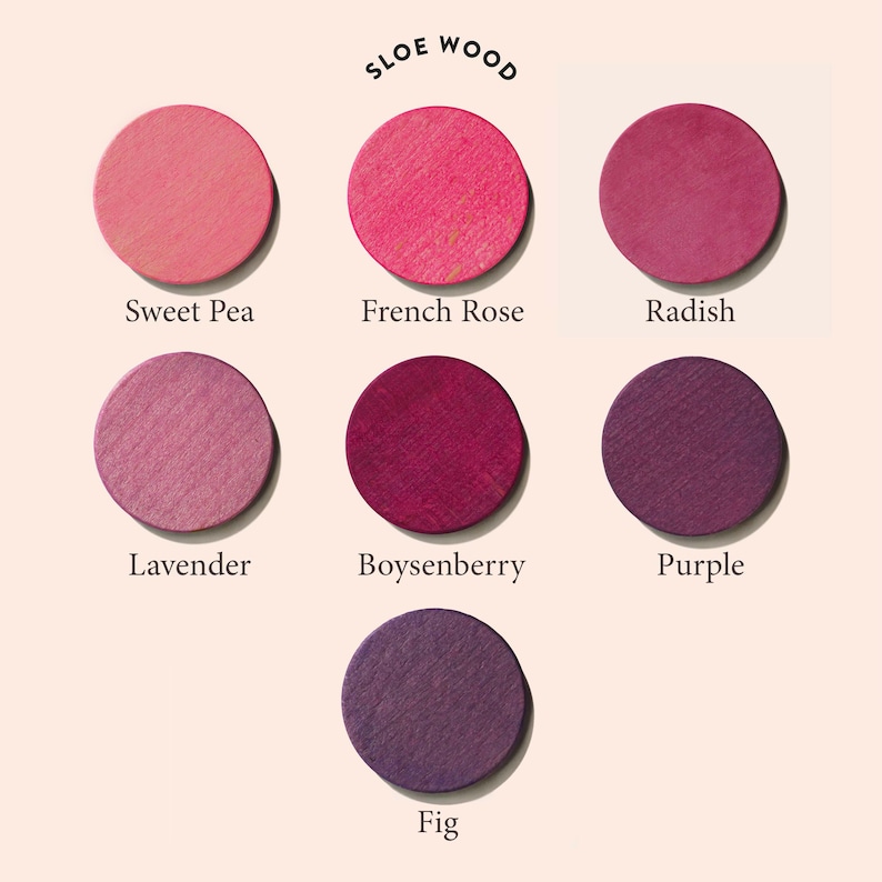 May include: Seven round, colorful, wooden discs with names written below each disc. The names are Sweet Pea, French Rose, Radish, Lavender, Boysenberry, Purple, and Fig. The text "SLOE WOOD" is written in a circle above the discs.