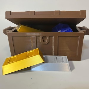 May include: A brown wooden treasure chest with a hinged lid is open, revealing a blue gemstone and two gold bars. Two more gold bars and a silver bar are in front of the chest.