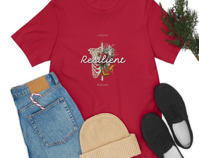 RESILIENT SHIRT, She Is Strong, Taylor Swift Shirt, Scripture Shirt, Best Selling Shirt, Strong Woman Unisex Jersey Short Shirt