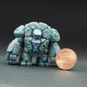 Painted rock golem miniature