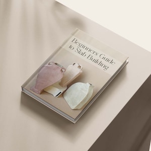 May include: A book titled "Beginners Guide to Slab Building" with a beige cover and a photo of four ceramic vases on the front.