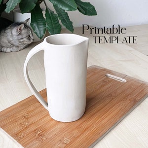 May include: White ceramic pitcher with a handle on a wooden cutting board. Printable TEMPLATE text is visible in the background.