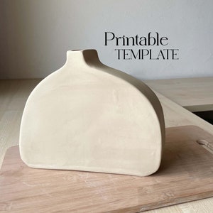 May include: Printable template for a ceramic vase. The vase is a light beige colour and has a rounded, organic shape.