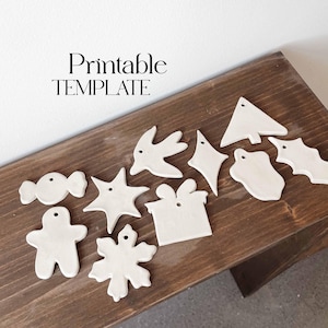 May include: Printable template for making ceramic Christmas ornaments. The template includes a variety of shapes, including a star, a tree, a bird, a gingerbread man, a candy cane, a snowflake, a present, and a heart.