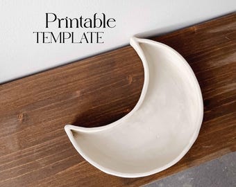 May include: A white ceramic crescent moon shaped dish on a brown wooden surface. The text "Printable TEMPLATE" is visible above the dish.