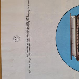 May include: A blue and white illustration of a ship with a white hull and a blue sail. The ship is surrounded by a blue circle. The text "Imprim&eacute; en Belgique par Casterman, s.a., Tournai, septembre 1984. N&deg; &eacute;dit.-impr. 1496. D&eacute;p&ocirc;t l&eacute;gal: 4&ordm; trimestre 1954; D. 1979/0053/12." is printed below the image.