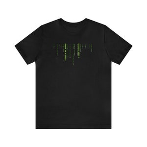 May include: Black t-shirt with a green and yellow matrix code design.