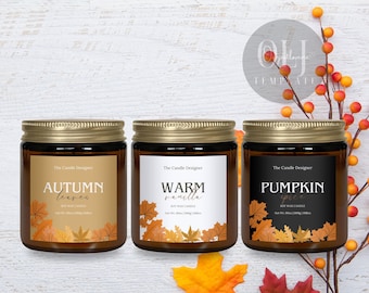 May include: Three glass jar candles with gold lids and labels. The labels read "Autumn Leaves", "Warm Vanilla", and "Pumpkin Spice". Each label features fall leaf illustrations. The candles are on a white wooden surface.