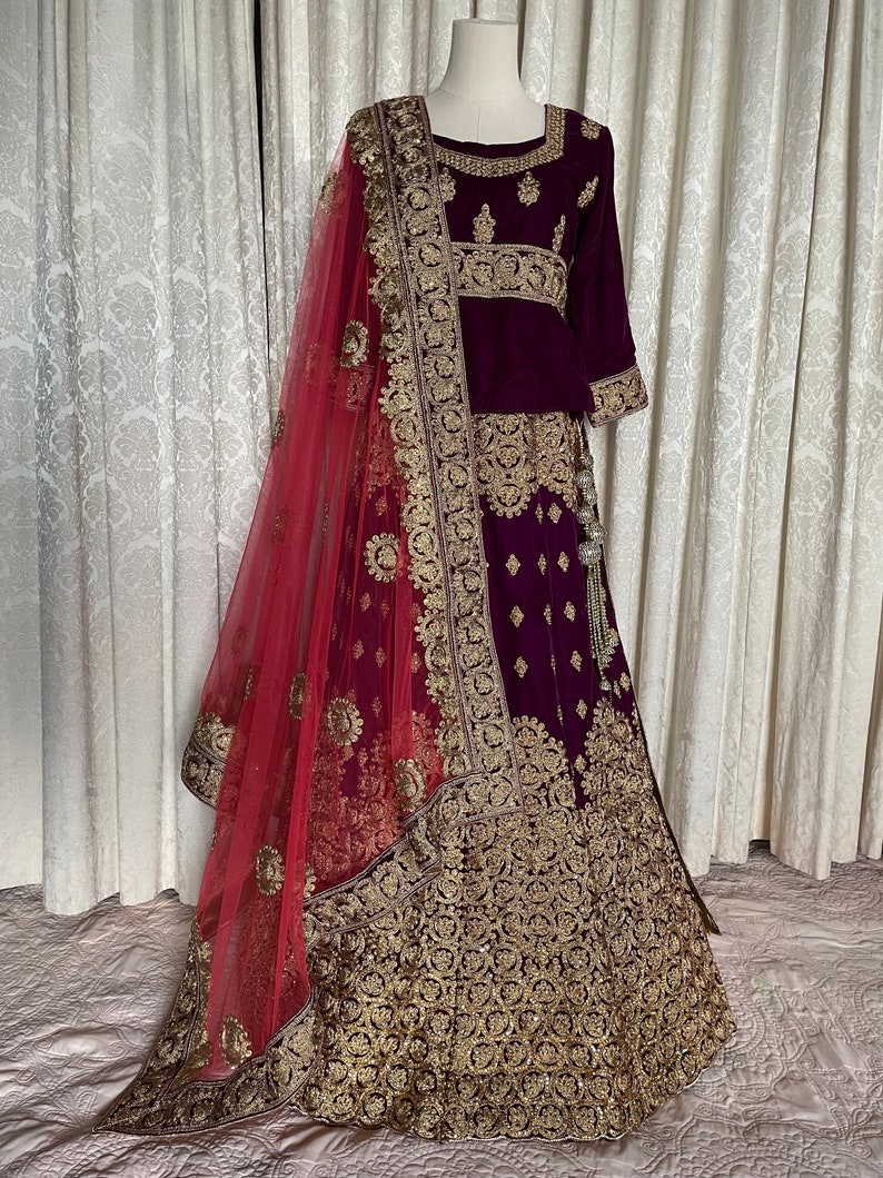 Royal Grandeur bridal Purple Soft Net Lehenga with Paisley and Peacock Motifs & Heavy Embroidery