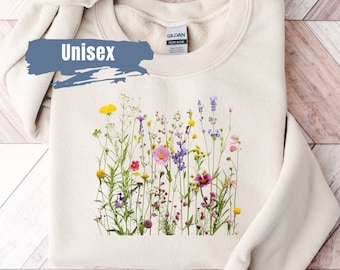Könnte beinhalten: Ein beiger Unisex-Sweatshirt mit einem floralen Druck aus verschiedenen bunten Blumen, darunter rosa, lila, gelb und rot.