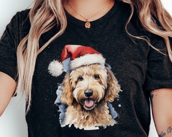 May include: Dark gray t-shirt featuring a watercolor illustration of a golden doodle wearing a Santa hat. The dog has a happy expression with its tongue out. The design includes blue watercolor accents.