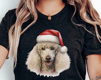 May include: A black t-shirt with a white poodle wearing a red Santa hat. The poodle is looking directly at the camera.