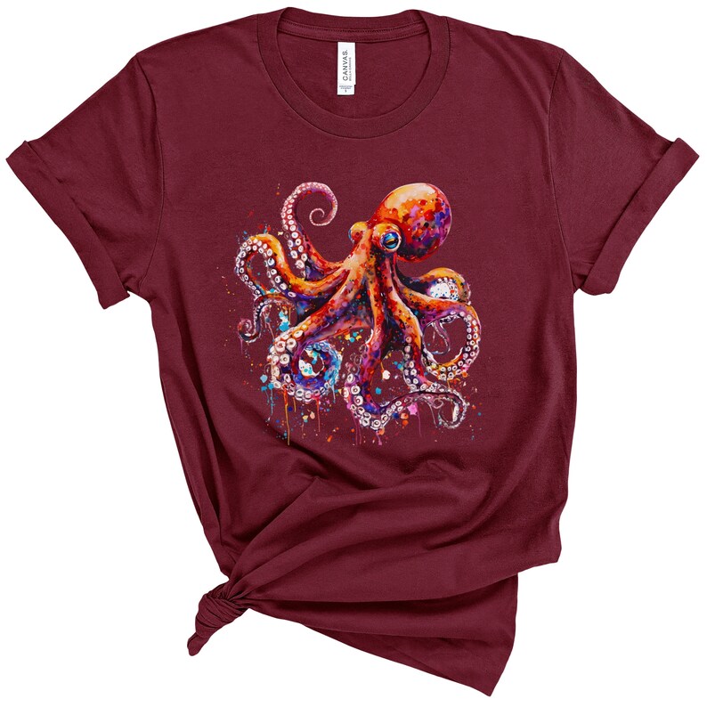 Puede incluir: Una camiseta color burdeos con un gr&aacute;fico de pulpo colorido. El pulpo est&aacute; pintado en tonos de rojo, naranja, morado y azul, con salpicaduras de pintura blanca a su alrededor.