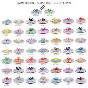 May include: Color chart of satin ribbon with plain edges, showcasing a variety of colors like Antique Blue, Apple Green, and Black. Each color is displayed as a small bow on a white disc, with the ribbon name printed below. The chart includes a ruler graphic.