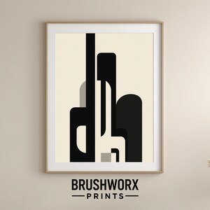 Peut inclure: Impression d'art encadrée avec des formes géométriques noires et crème. L'œuvre d'art a un design minimaliste et une esthétique moderne. L'impression est encadrée dans un cadre en bois et porte le texte "BRUSHWORX - PRINTS" en bas.