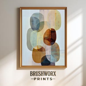 May include: Abstract art print in a wooden frame. The artwork features overlapping oval shapes in shades of blue, brown, yellow, and green. The text "BRUSHWORX -PRINTS-" is at the bottom of the frame.