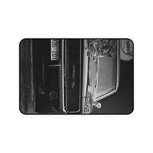 May include: Black and white photo of a classic Dodge Charger muscle car with a custom engine and the license plate "XBG 201".