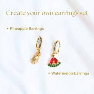 14K Gold-filled pineapple and watermelon earrings. The red and green zircon looks shining on the watermelon charm. These earrings are designed with fruit charms that exude elegance and playfulness. A perfect daughter present, A plant mom gift.