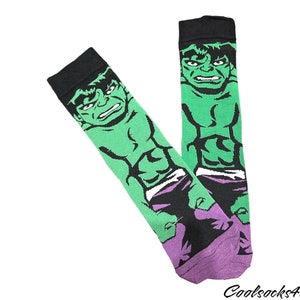 May include: A pair of black and green socks with a graphic print of the Hulk. The socks have purple accents around the ankle.