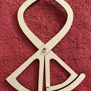 May include: A wooden measuring tool with a circular scale and a pair of arms that can be adjusted to measure the circumference of an object.