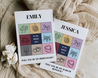 May include: Two white cards with colorful illustrations and text. The top card says "EMILY" and "WILL YOU BE MY BRIDESMAID?" The bottom card says "JESSICA" and "WILL YOU BE MY MAID OF HONOUR?"