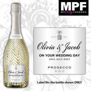 May include: A bottle of Prosecco with a textured glass surface and a custom silver label featuring the text Olivia & Jacob, ON YOUR WEDDING DAY, 20th JULY 2027, PROSECCO D.O.C, and ESTD 1861. The label is also shown separately in a larger view.