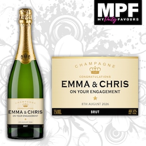 May include: A green glass champagne bottle with a gold foil neck wrap and a custom label featuring the text "CHAMPAGNE CONGRATULATIONS EMMA & CHRIS ON YOUR ENGAGEMENT 8TH AUGUST 2026 BRUT". The label includes a gold crown icon and a small star.