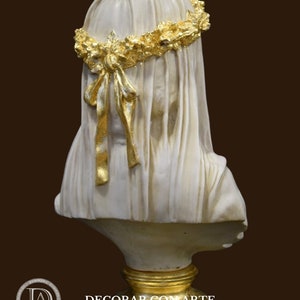 May include: White plaster bust of a woman wearing a gold leaf crown and veil. The bust is on a gold leaf base.