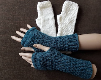 May include: Two pairs of fingerless gloves, one pair is white and the other is teal.