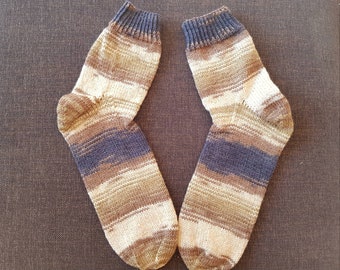 May include: A pair of striped socks in brown, beige, and blue colors. The socks are knitted and have a ribbed texture.