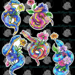 May include: A collection of colorful snake stickers. The snakes are depicted in vibrant blues, pinks, and yellows, adorned with flowers. Each sticker features a unique design, with some showcasing starry patterns and others with intricate color gradients. The stickers are on a black background.