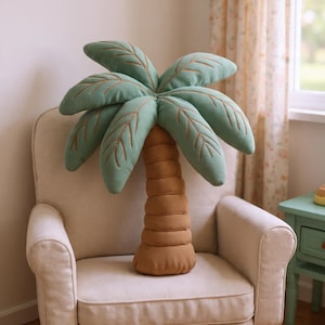 Cojín con forma de palmera: estampado de doble cara y recortes para decoración tropical.