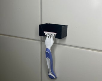 Razor wall holder for adhesive