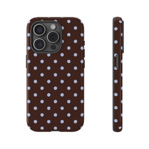 May include: A brown phone case with a repeating pattern of light blue polka dots. The case is shown from the front and side, highlighting the design and the camera cutouts.