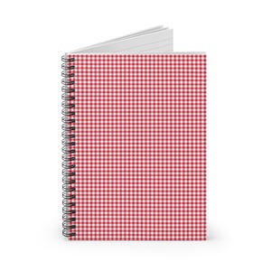 May include: A spiral-bound notebook with a red and white gingham pattern cover. The notebook is open, revealing lined white pages. The spiral binding is black.
