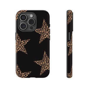 May include: Black phone case with a leopard print star pattern. The case has a glossy finish and a protective design. The leopard print stars are in shades of brown and tan. The case is shown from the front and side.