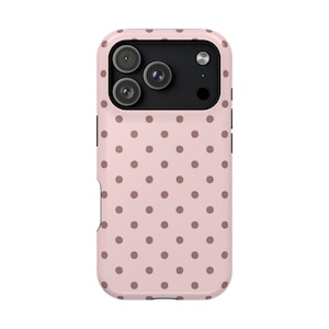 May include: A pink phone case with a repeating pattern of brown polka dots. The case has a camera cutout with three lenses and a flash. The case is designed to protect the phone from scratches and damage.
