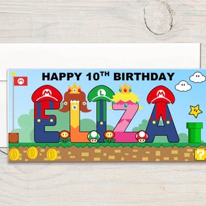 May include: A birthday card with a Super Mario theme. The card says "HAPPY 10TH BIRTHDAY ELIZA" in colourful, stylised letters. The background features elements from the game, including a flag, coins, and a green pipe.