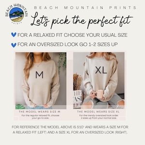May include: Image from Beach Mountain Prints showing how to choose the right sweatshirt size. The image shows two models wearing sweatshirts, one size M and one size XL. Text advises choosing usual size for relaxed fit, or 1-2 sizes up for oversized look.