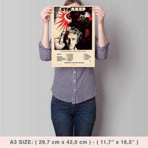 May include: A vintage movie poster for the film "Stalker" featuring a man with a crown of thorns and a red and black background. The poster is printed in Russian and includes the film's title, director, and cast.