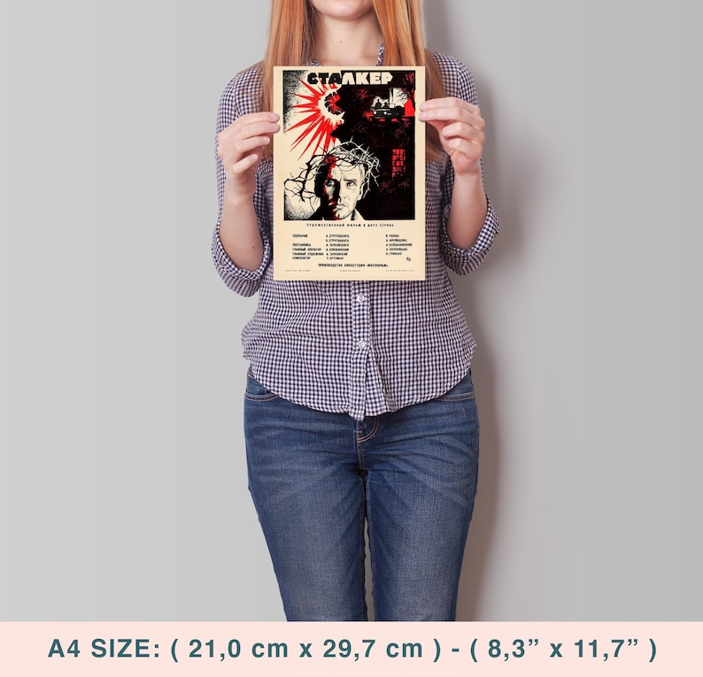 May include: A vintage-style poster for the film "Stalker" featuring a man's face with a crown of thorns and a red sunburst in the background. The poster is printed on a cream-colored paper with black and red text. The poster measures 8.3 inches by 11.7 inches.