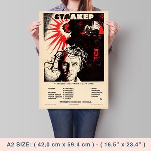 May include: A vintage movie poster for the film "Stalker" in red, black, and white. The poster features a man with a crown of thorns and the title of the film in Cyrillic script. The poster also includes the film's credits in Russian.