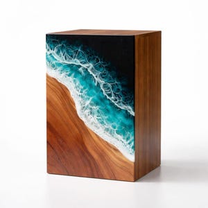 May include: A wooden box with a beach scene design. The box features a dark wood finish on the sides and top. The front panel has a resin design depicting a turquoise ocean with white waves meeting a brown sandy shore.