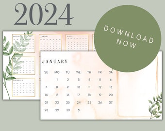 May include: A printable 2024 calendar with a watercolour background in shades of pink and peach. The calendar features a gold frame and green leaves. The month of January is highlighted with the text "JANUARY" in black.