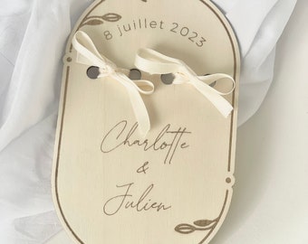 Wooden wedding ring holder engraved with first names and date