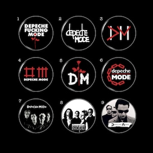 May include: A collection of nine Depeche Mode button pins with various designs. The pins feature the band's logo, album art, and band member photos. The pins are circular with a glossy finish and are set against a black background.